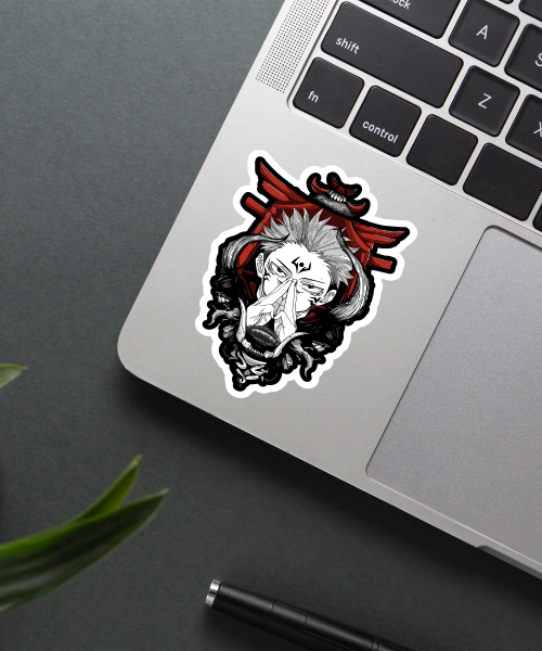 sukuna grin sticker on laptop surface showing bold anime style