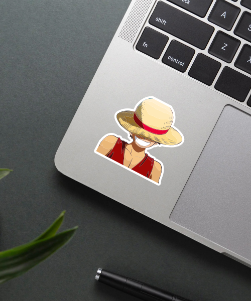 luffy sticker on laptop surface showing straw hat and smile