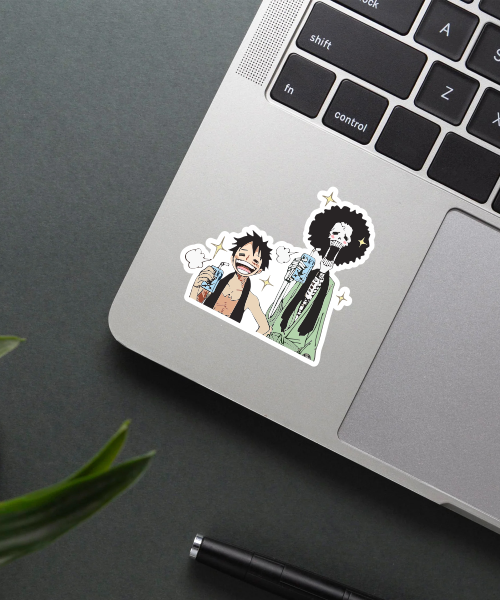 one piece luffy and brook sticker on laptop surface showing vibrant colors and clear details