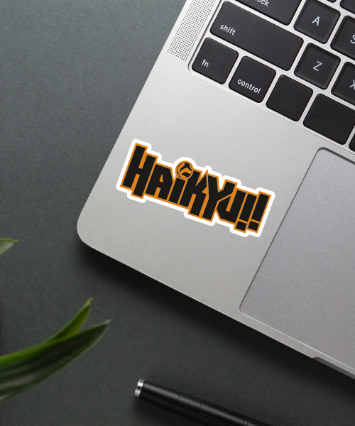 haikyuu logo anime sticker on laptop surface showing bold black and orange text