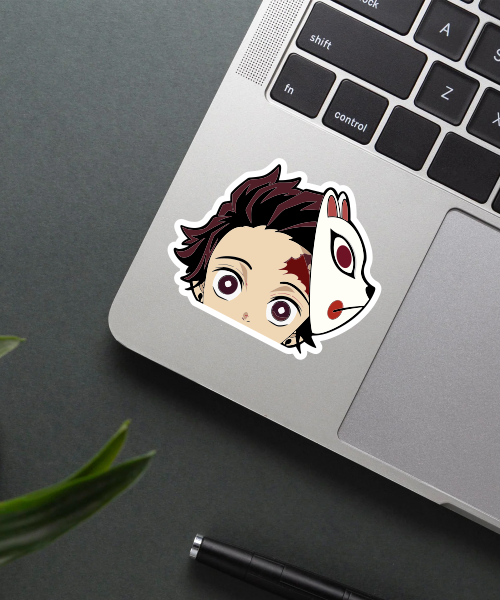 Tanjiro mask sticker on laptop showing fox mask tilted up with eyes and scar visible