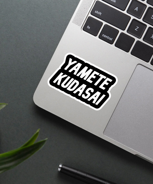 yamete kudasai sticker on laptop surface showing bold black white text